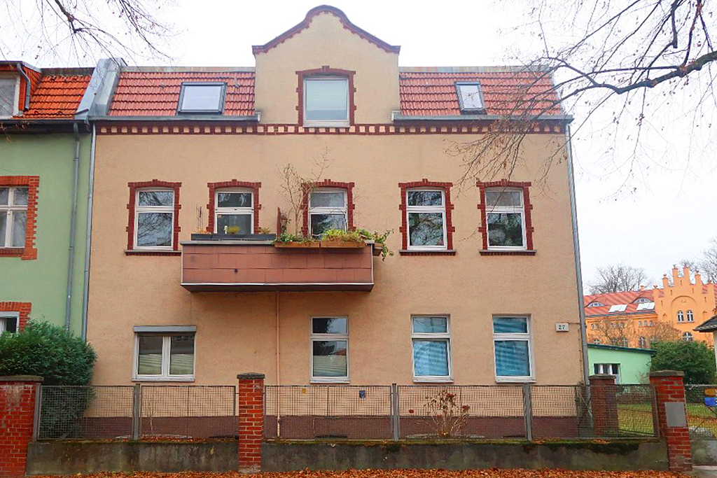 Wohnhaus mit 6 Parteien in Berlin-Reinickendorf, orange Außenfassade mit Balkon
