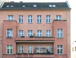 Mehrfamilienhaus in Berlin-Lichtenberg, rote Fassade mit Balkonen